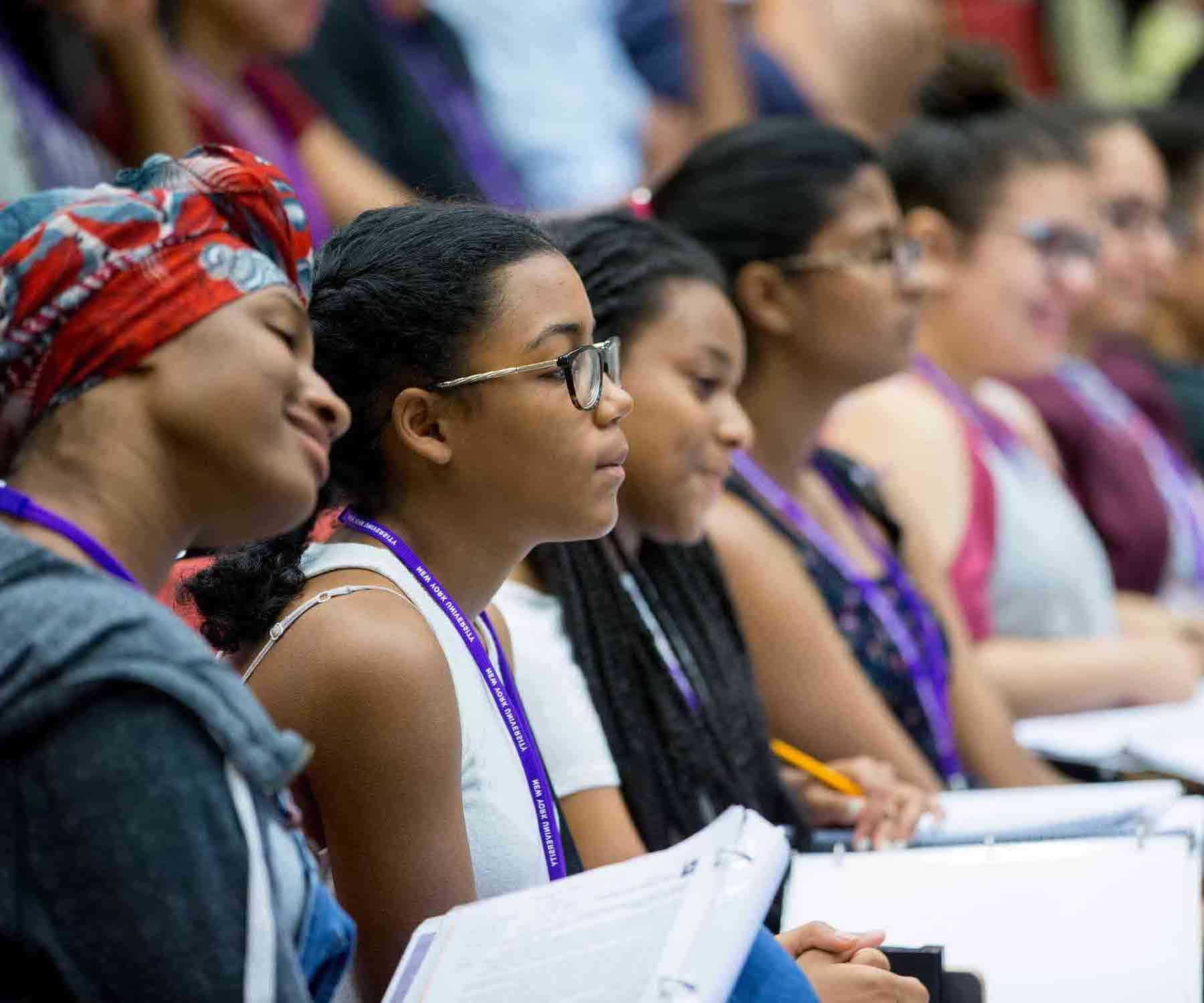 A row of attentive students listening to a presentation